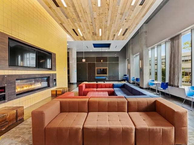 Sofa pool table fireplace modern living room at The Summit at University City in Philadelphia Student Accommodation
