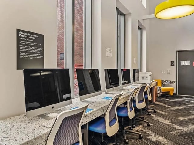 Row of computers with chairs Study Area at The Summit at University City in Philadelphia Student Accommodation