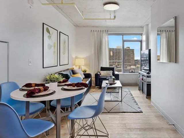 Dining table sofa coffee table living room at The Summit at University City in Philadelphia Student Accommodation