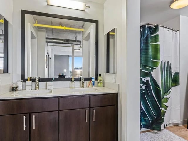 Double vanity sinks with tropical shower curtain Bathroom at The Summit at University City in Philadelphia Student Accommodation