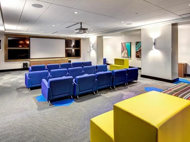 Blue theater seats projector screen artwork living room at The Summit at University City in Philadelphia Student Accommodation