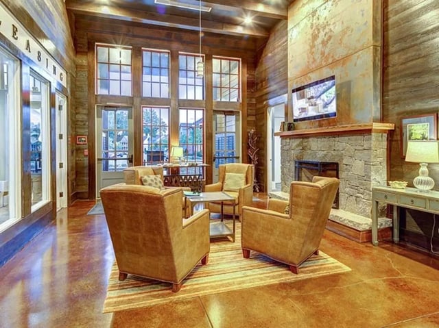 Lounge with stone fireplace and seating living room at The Cottages of Durham in Durham Student Accommodation