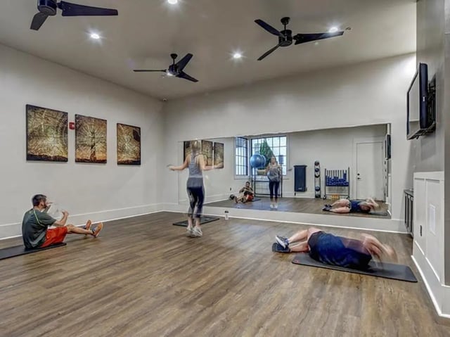 Gym with people exercising fitness area at The Cottages of Durham in Durham Student Accommodation