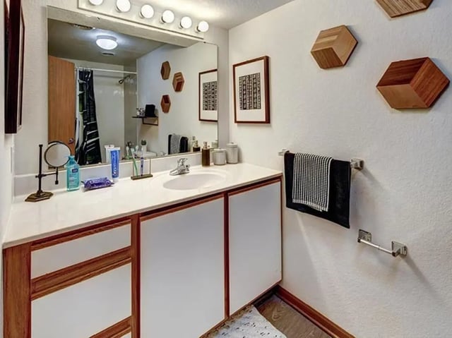 Sink countertop with toiletries and towels bathroom at The Tower at Third in Champaign Student Accommodation