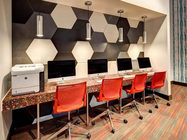 Computers printer red chairs study area at The Tower at Third in Champaign Student Accommodation