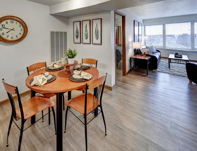 Dining table with chairs and living room view Dining area at The Tower at Third in Champaign Student Accommodation
