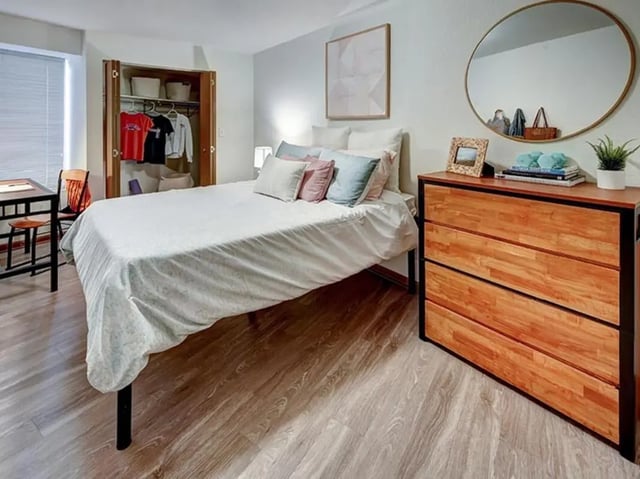 Bed dresser closet with clothes desk and chair bedroom at The Tower at Third in Champaign Student Accommodation