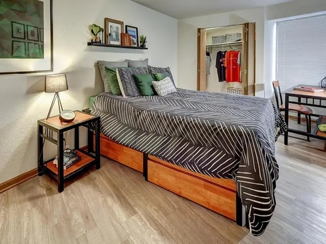Bed nightstand closet with clothes desk bedroom at The Tower at Third in Champaign Student Accommodation