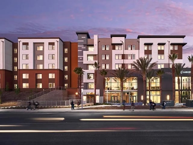 Modern multi-story building with palm trees exterior at Plaza Verde in Irvine Student Accommodation