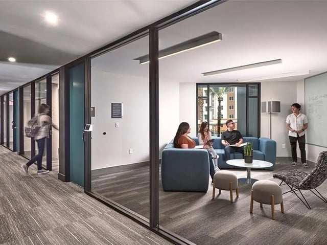Sofa stools table and chairs living room at Plaza Verde in Irvine Student Accommodation