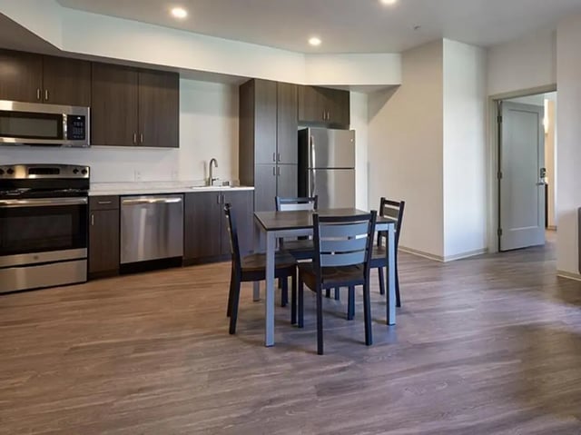 Kitchen with dining table and appliances kitchen at Plaza Verde in Irvine Student Accommodation