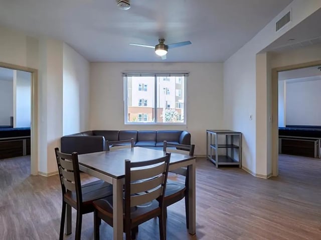 Dining table chairs sofa living room at Plaza Verde in Irvine Student Accommodation