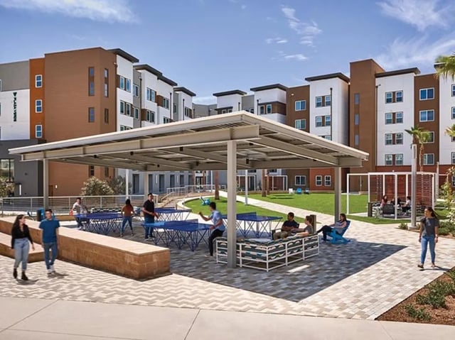Covered outdoor seating ping pong tables and green space Exterior at Plaza Verde in Irvine Student Accommodation