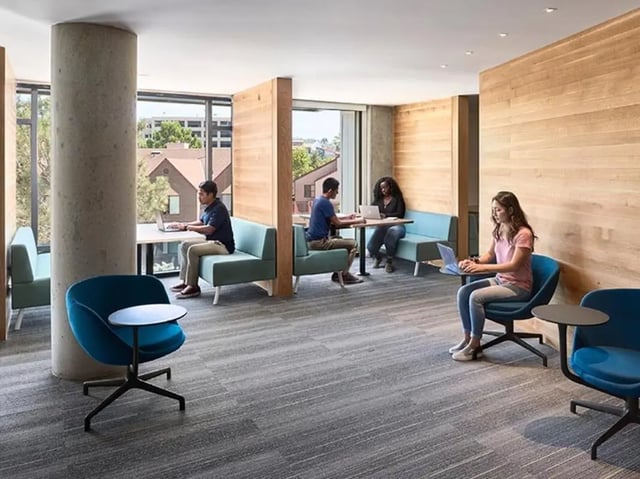 Students working laptops in communal study area at Plaza Verde in Irvine Student Accommodation