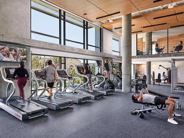 Treadmills stair climbers weight bench gym area at Plaza Verde in Irvine Student Accommodation