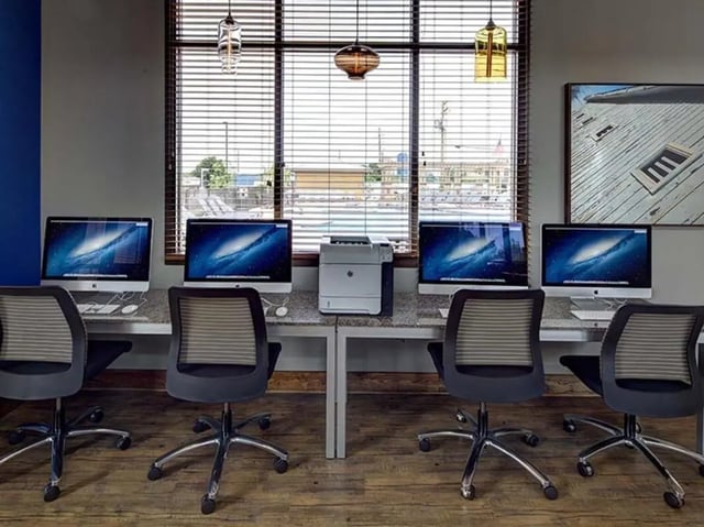 Four computers printer and chairs study area at The Townhomes at Newtown Crossing in Lexington Student Accommodation