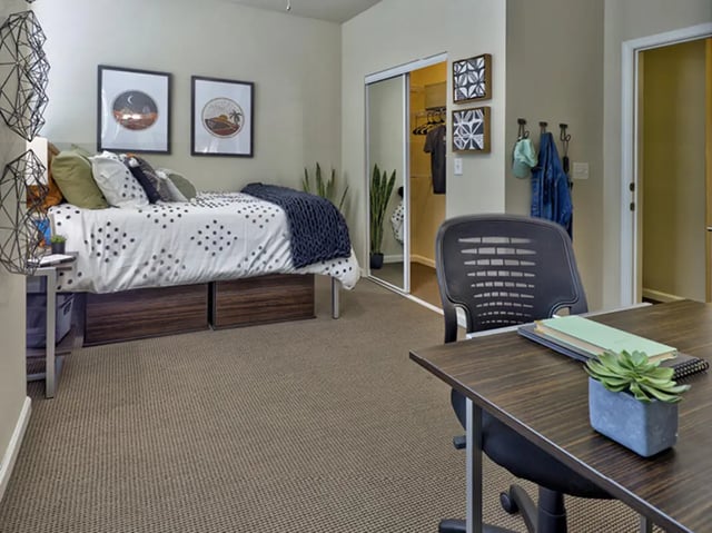 Bed desk closet door and chair bedroom at The Townhomes at Newtown Crossing in Lexington Student Accommodation