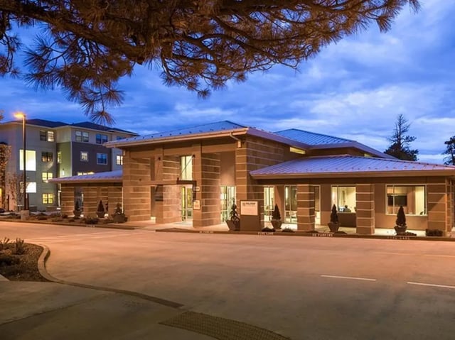 Modern entrance with stone columns and landscaped exterior exterior at Hilltop Townhomes in Flagstaff Student Accommodation