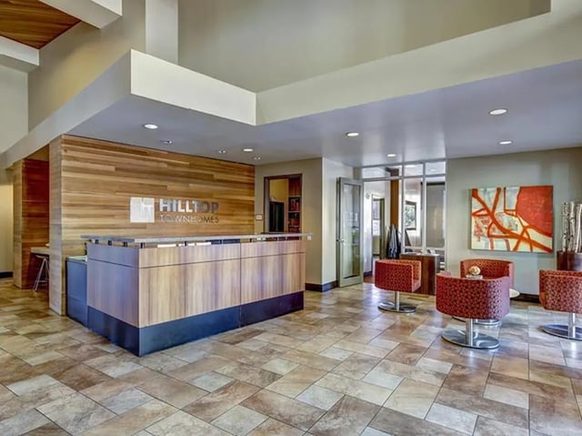 Reception desk wood wall seating area lounge at Hilltop Townhomes in Flagstaff Student Accommodation