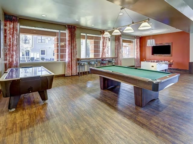 Pool tables foosball table and bar area living room at Hilltop Townhomes in Flagstaff Student Accommodation