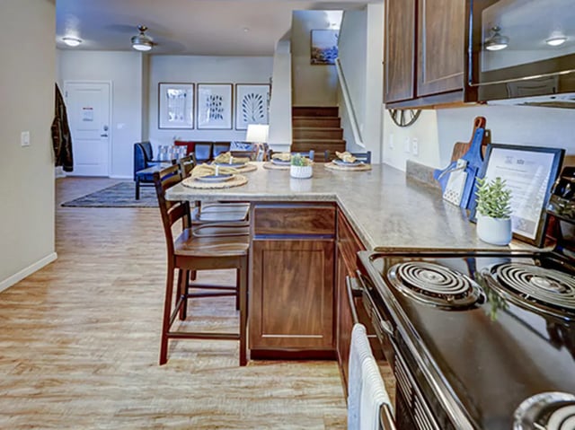 Kitchen island with bar stools and countertop kitchen area at Hilltop Townhomes in Flagstaff Student Accommodation