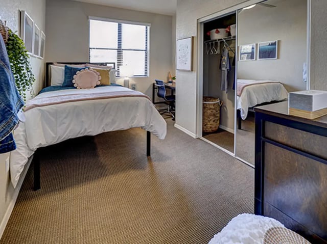Bed closet desk and mirrored wardrobe bedroom at Hilltop Townhomes in Flagstaff Student Accommodation