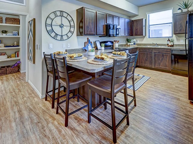 Kitchen island with chairs and open shelves kitchen at Hilltop Townhomes in Flagstaff Student Accommodation