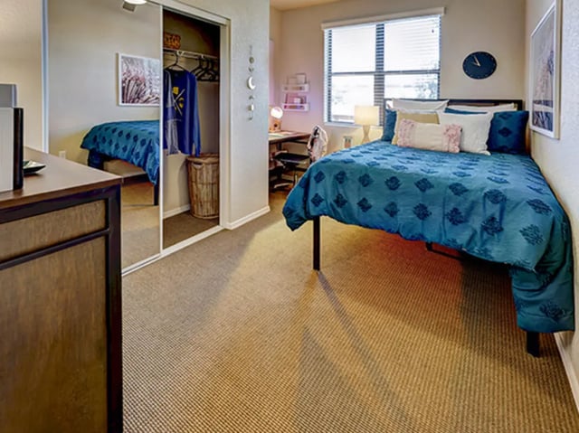 Bed closet and desk in student bedroom at Hilltop Townhomes in Flagstaff Student Accommodation