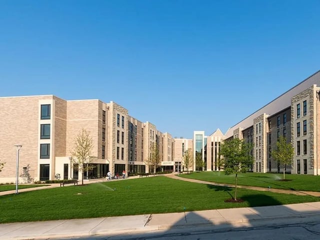 Modern student accommodation buildings with grassy quad exterior at Honors Academic Village in Toledo Student Accommodation