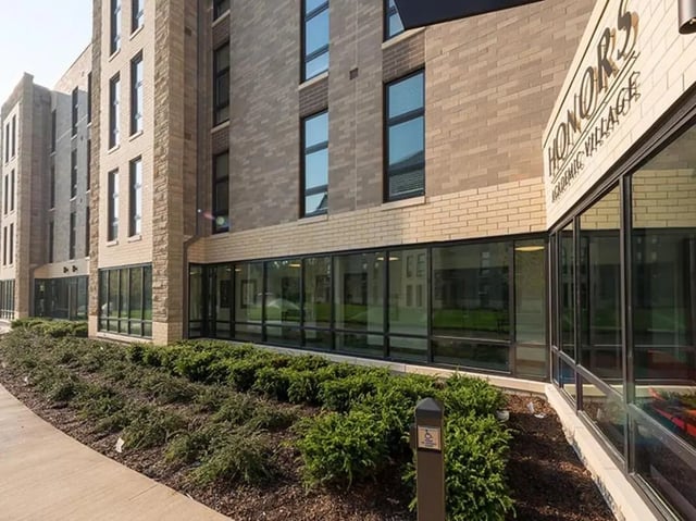 Modern brick building with large windows and landscaping exterior at Honors Academic Village in Toledo Student Accommodation