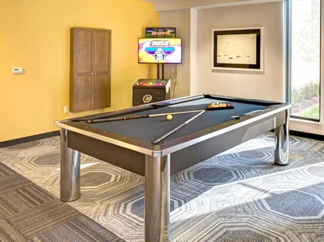 Pool table with cues and balls playing area at Honors Academic Village in Toledo Student Accommodation