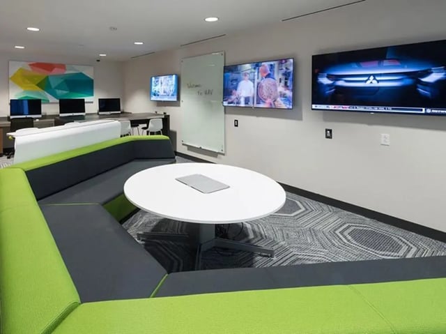 Modern lounge with curved seating and white table Living room at Honors Academic Village in Toledo Student Accommodation