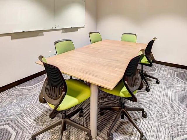 Conference table with green chairs whiteboard Study area at Honors Academic Village in Toledo Student Accommodation