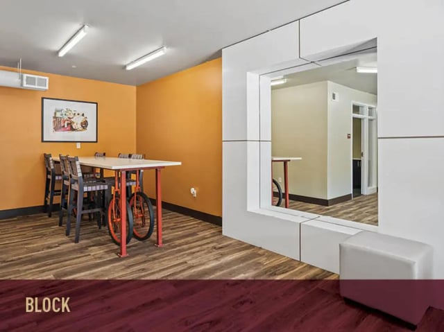 Table chairs artwork in dining area at Stadium Centre - The Axis in Tallahassee Student Accommodation