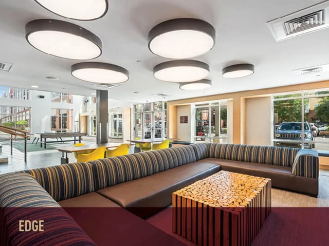Sectional couch wooden coffee table ping pong living room at Stadium Centre - The Axis in Tallahassee Student Accommodation