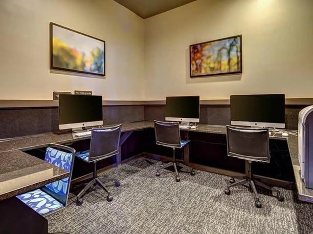Computers and chairs arranged in a business center at The Province in Tampa Student Accommodation
