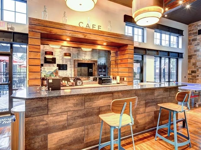 Cafe counter with bar stools and ping pong table. at The Province in Tampa Student Accommodation