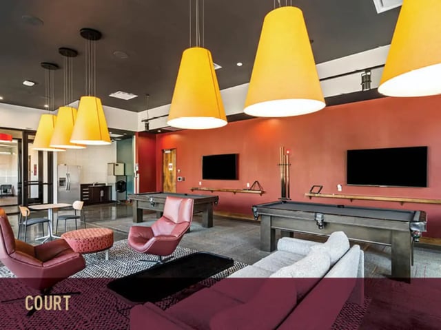 Pool tables chairs sofas televisions lounge area at Stadium Centre - The Block in Tallahassee Student Accommodation