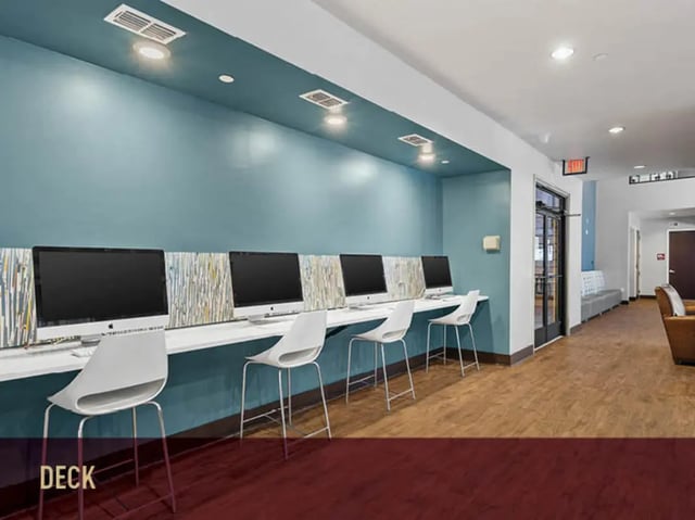 Computers and chairs with wall decor study area at Stadium Centre - The Block in Tallahassee Student Accommodation