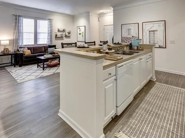 Leather sofa coffee table kitchen island living room kitchen at The Province in Rochester Student Accommodation