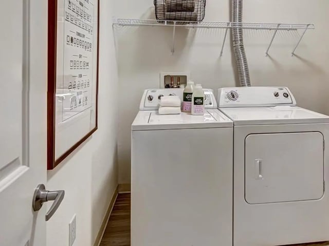 Laundry machines towels and cleaning supplies laundry room at The Province in Rochester Student Accommodation