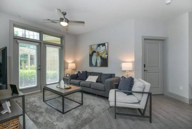 Sofa coffee table chairs artwork doors ceiling fan living room at 114 Earle in Clemson Student Accommodation