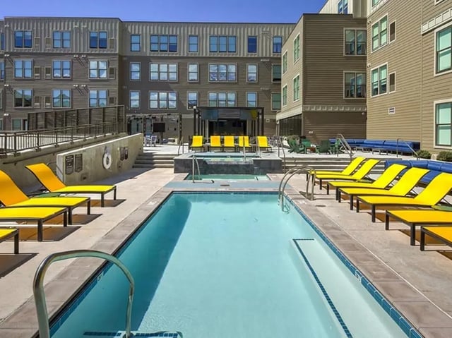 Pool lounge chairs and buildings exterior at The Jack in Flagstaff Student Accommodation