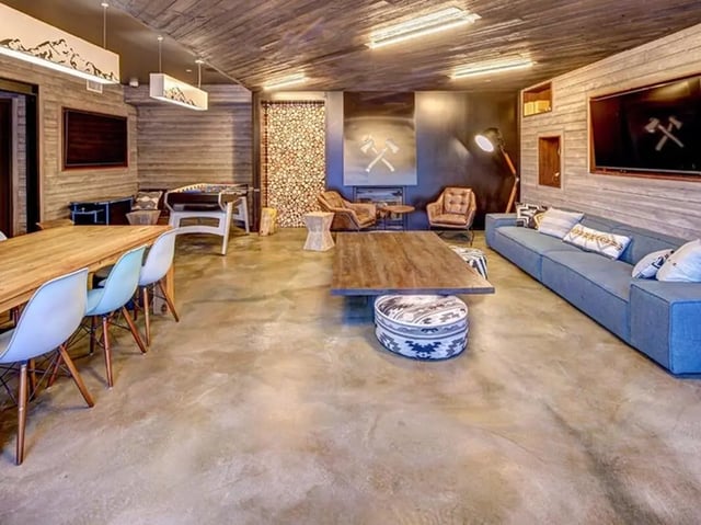 Ping pong table couches chairs fireplace living room at The Jack in Flagstaff Student Accommodation