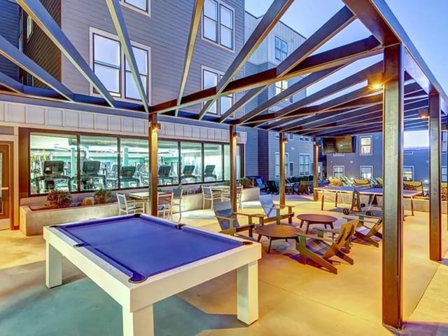 Billiards table tables chairs patio living area at The Jack in Flagstaff Student Accommodation