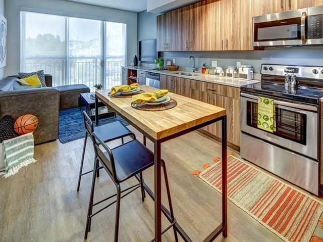Sofa basketball dining table kitchen with appliances living room kitchen at The Jack in Flagstaff Student Accommodation