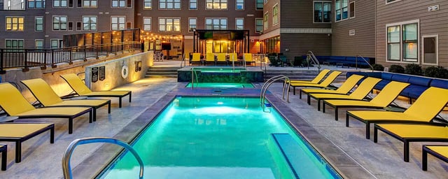 Pool spa lounge chairs and building exterior at The Jack in Flagstaff Student Accommodation