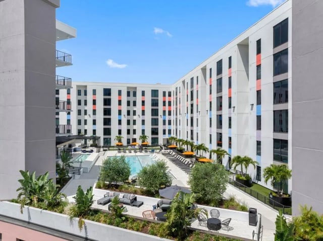 Modern courtyard pool area with lounge chairs and seating exterior at Apella on Newport in Tampa Student Accommodation