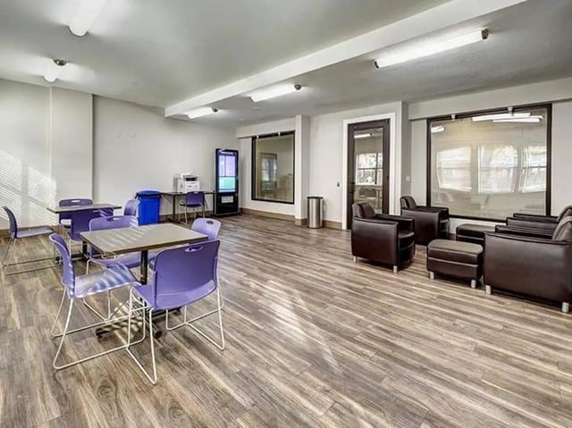 Study area with purple chairs and brown leather furniture living room at The Block on 28th in Austin Student Accommodation
