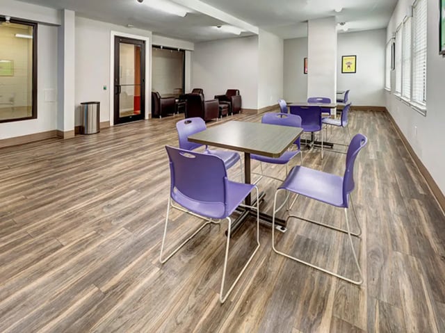 Purple chairs and tables in common area at The Block on 28th in Austin Student Accommodation